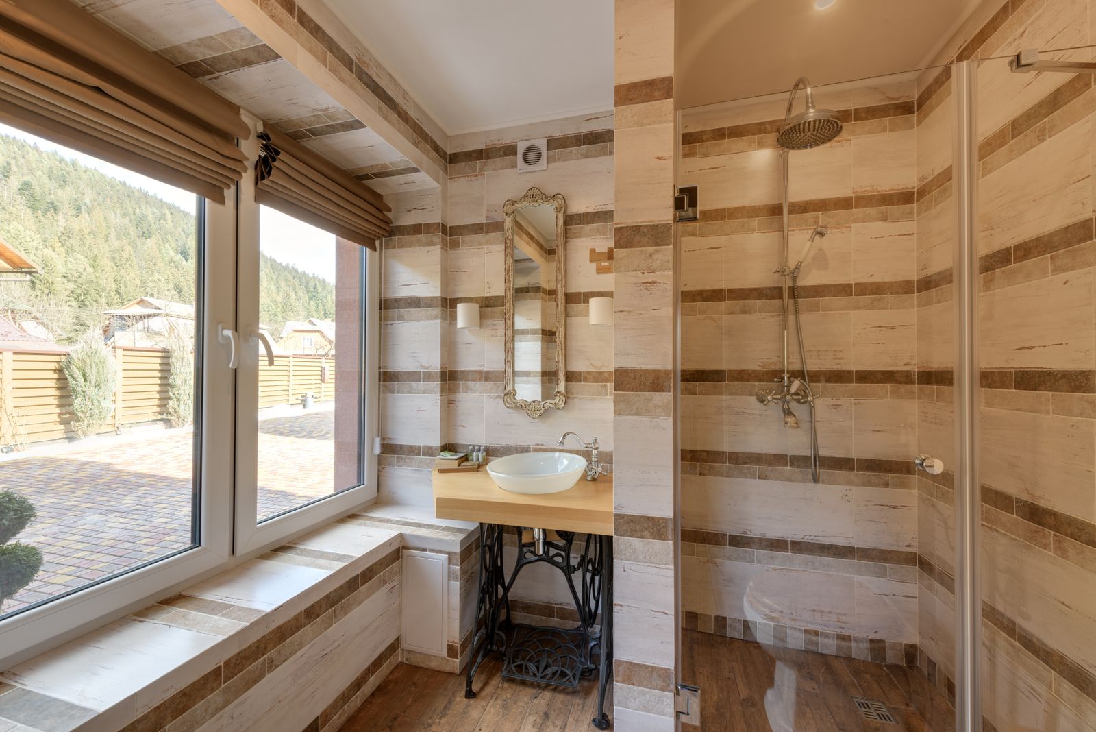 A bright ensuite with a separated wet area behind a single run of glass